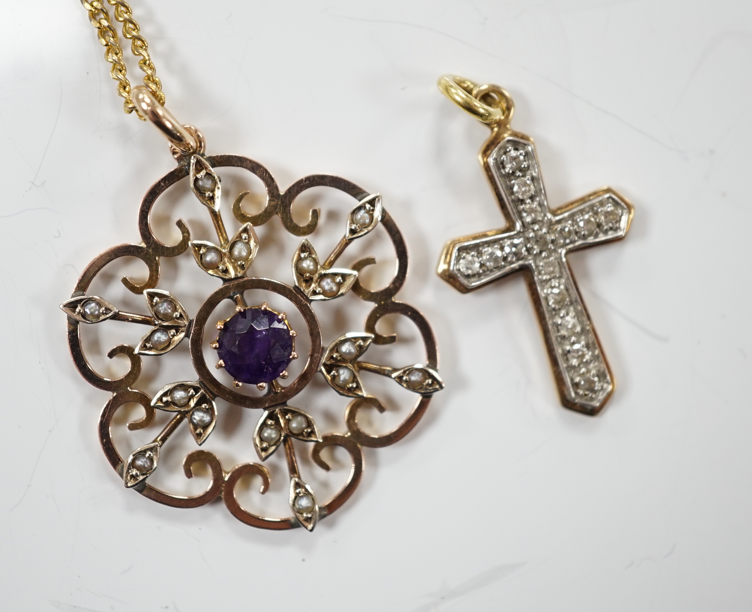 An early 20th century yellow metal, amethyst and seed pearl set pendant, 32mm, on a gilt metal chain, together with a modern yellow metal and diamond set cross pendant.